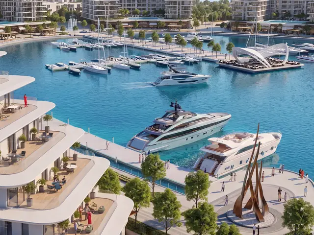 Yachts moored in the Ramhan marina below terraced residences
