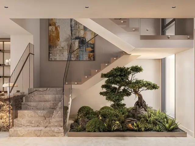 Double-height villa hall with a sculptural staircase
